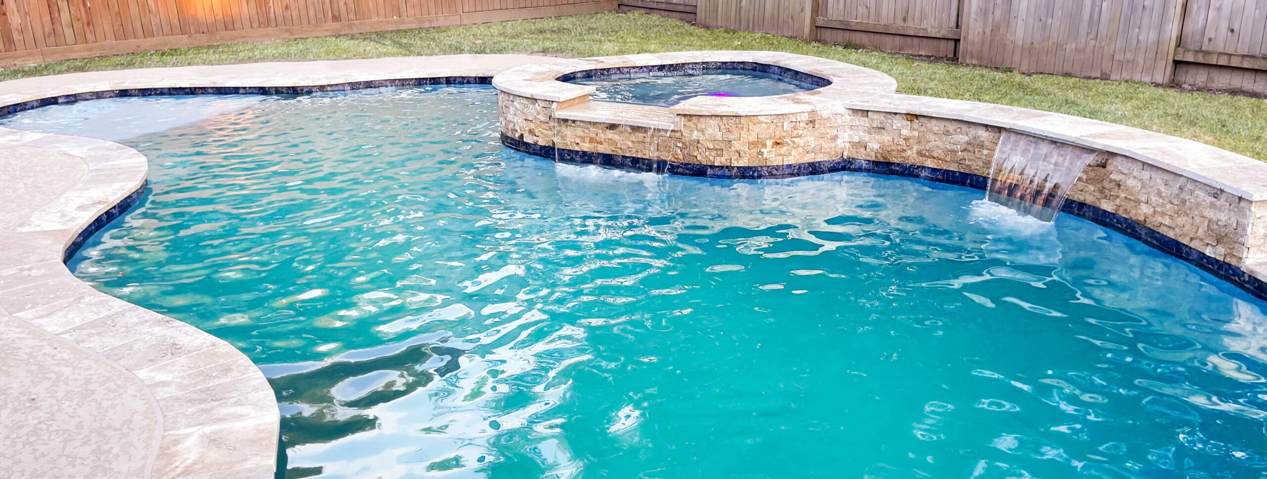 Curvy gunite pool and spa in Metroplex.