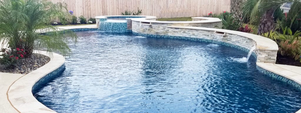 Free-form Dallas pool with cascade water feature.