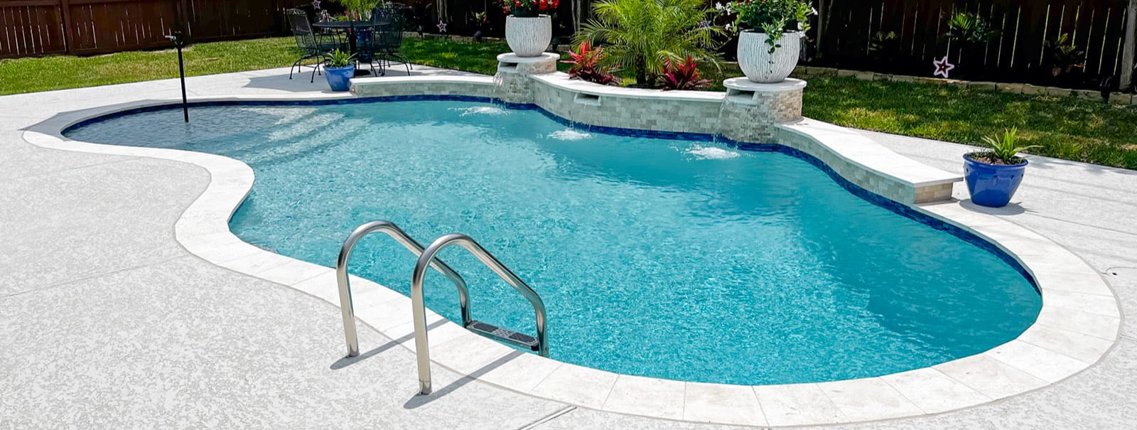 Curvy gunite pool with raised bond beam water feature in Houston.