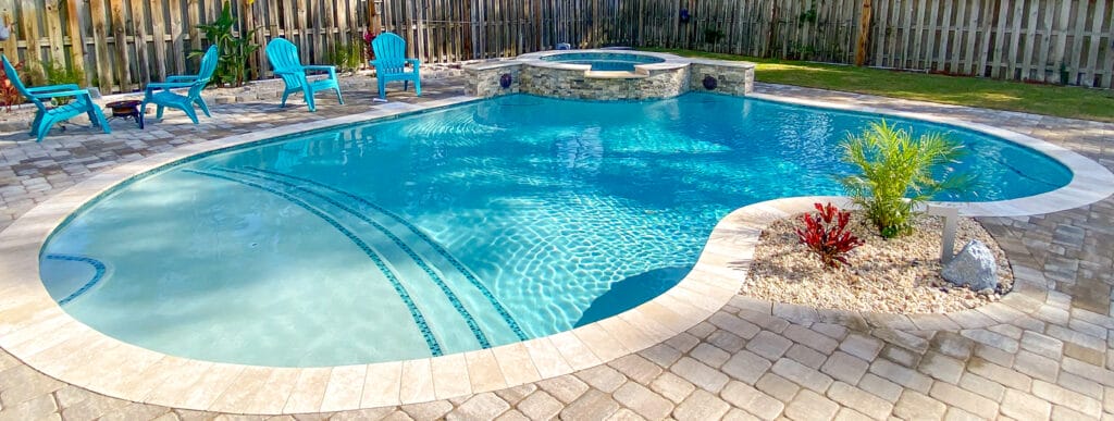Mobile free-form inground pool with large tanning-ledge-style entry step.