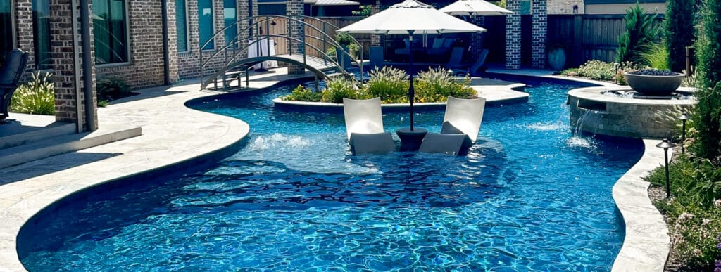 Oklahoma City pool with a pedestrian bridge and a miniature island in the center of the pool.