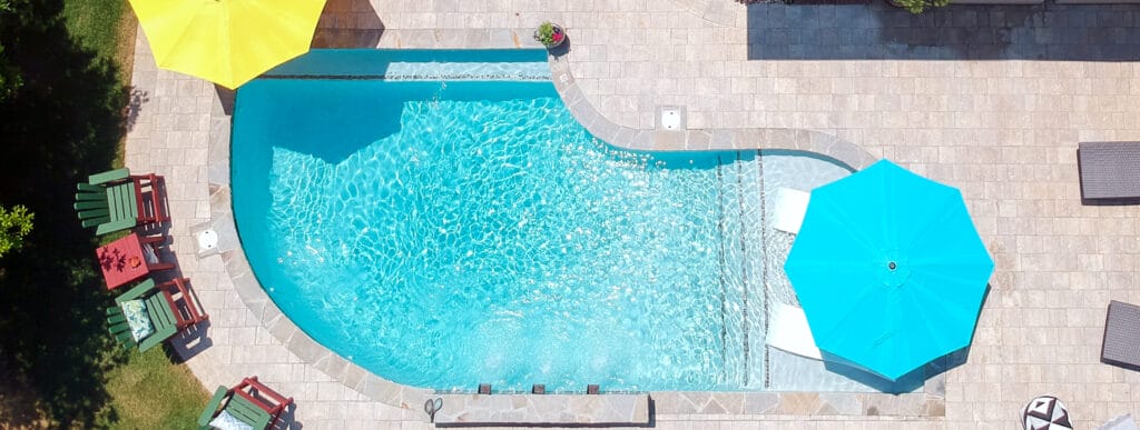 Geometric-shaped swimming pool in Pensacola backyard.