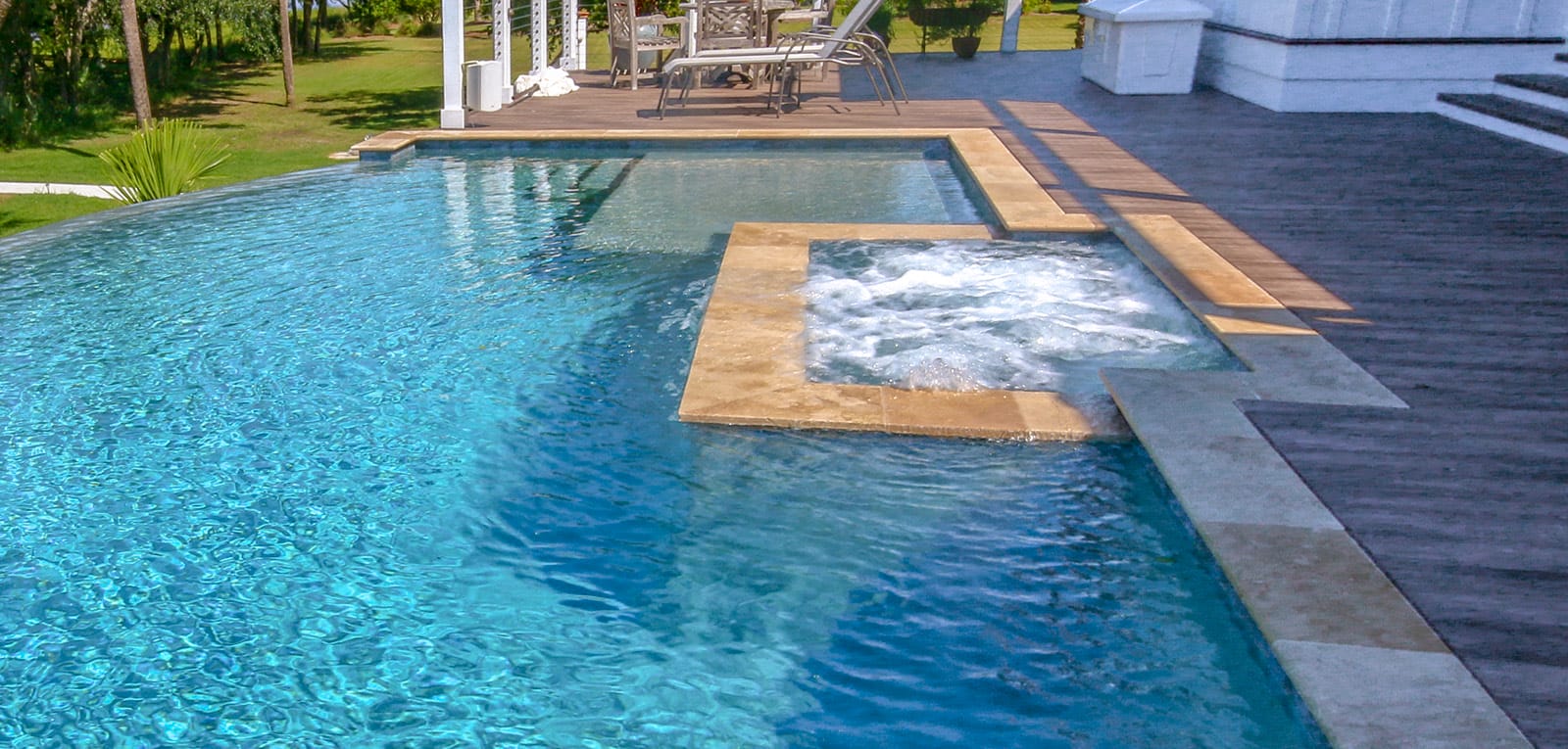 Infinity pool with bubbling rectangular spa.