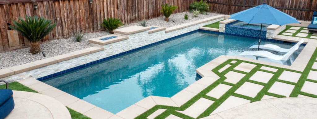 Geometric inground pool in a fenced backyard in Ontario. 