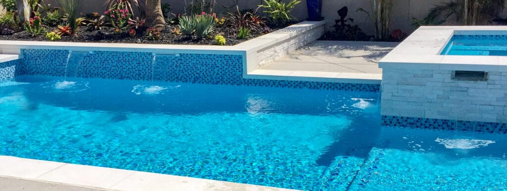 Ontario inground swimming pool & spa with cascade water features.