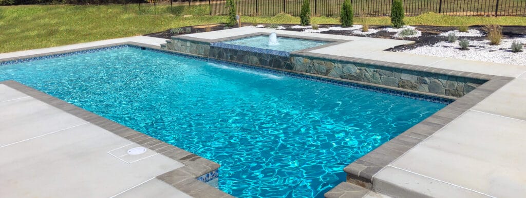 Rectangular St. Mary’s County swimming pool with multi-tier decking and elevated spa.