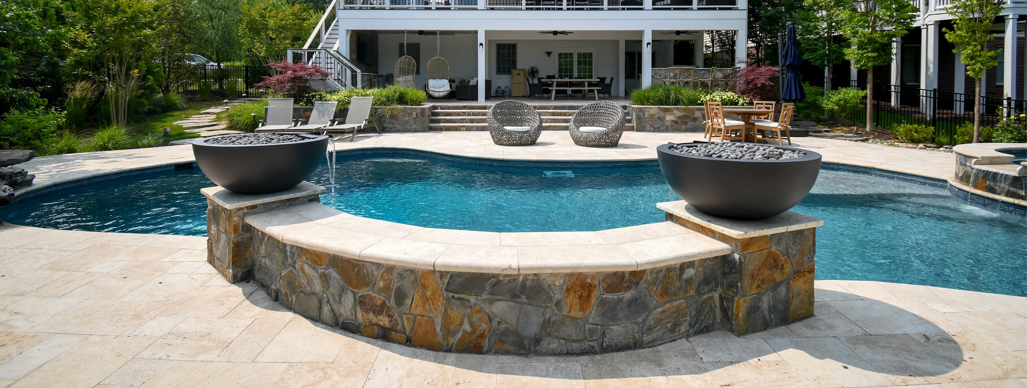 Twin fire bowls atop a concrete sitting wall on a gunite pool in Mechanicsville. 