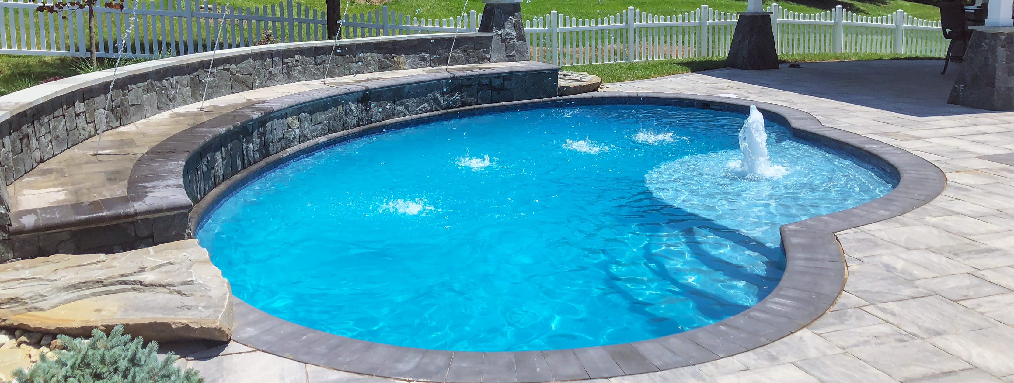 inground pool with sun ledge and multiple water features in Chevy Chase.