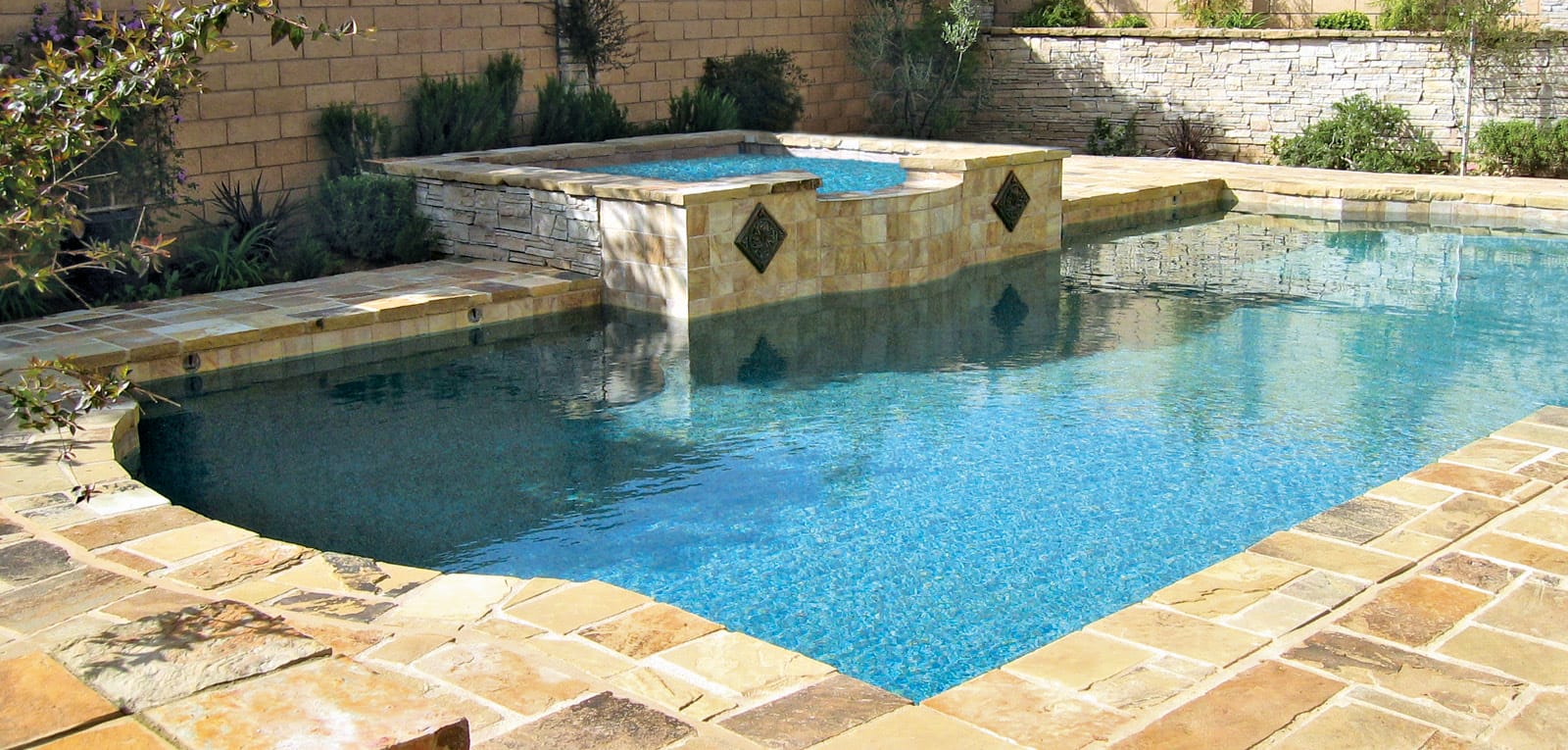 Backyard Roman pool with square gunite spa.