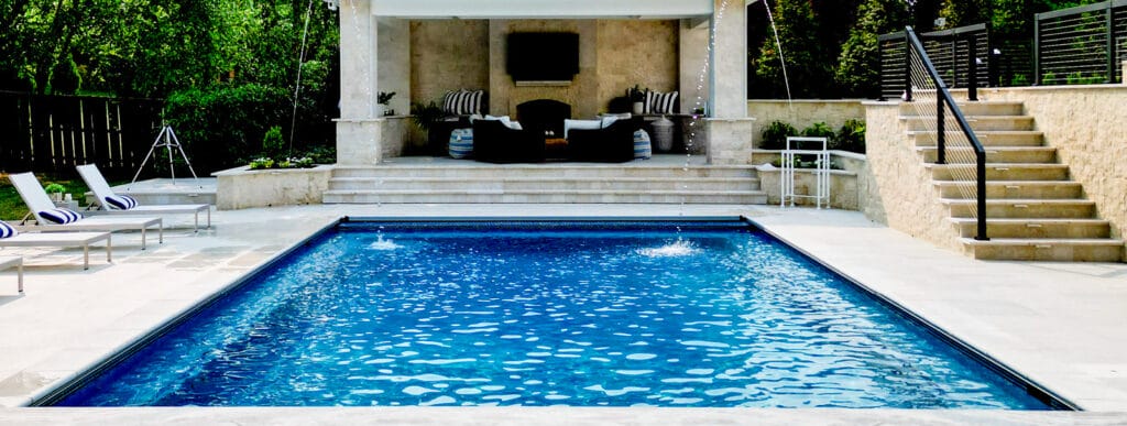 Fairfax inground pool with sleek, arching water features.