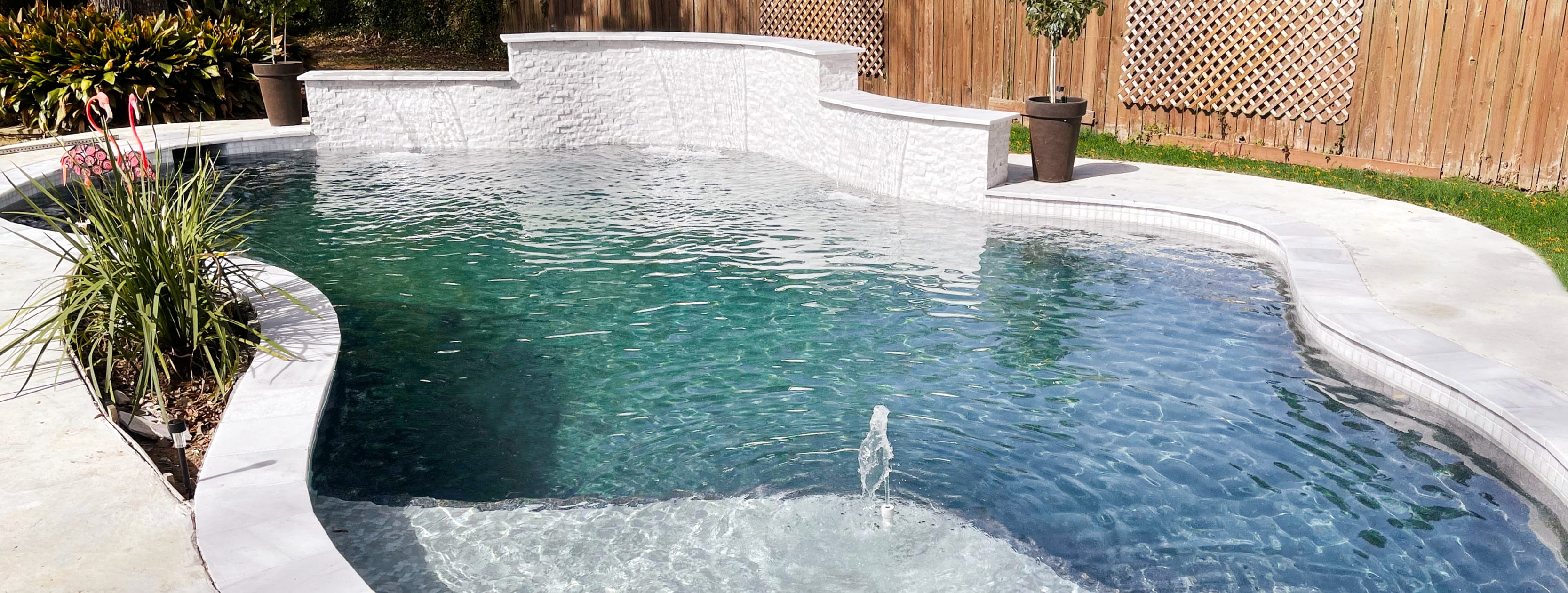 Free-form gunite poo with bubbler fountain l in Port Arthur backyard.