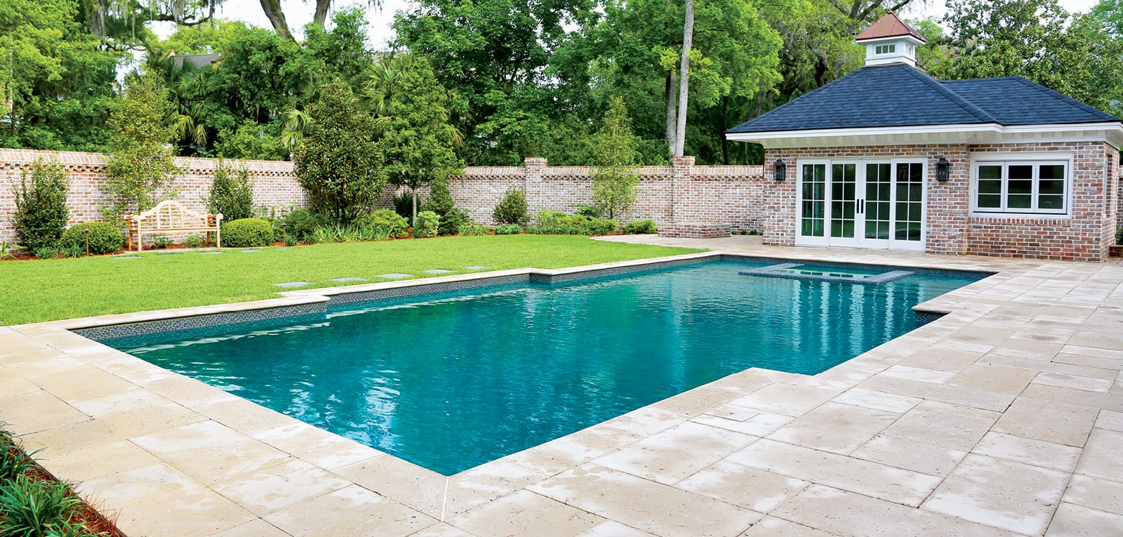 Modified rectangle-shaped pool in a backyard.