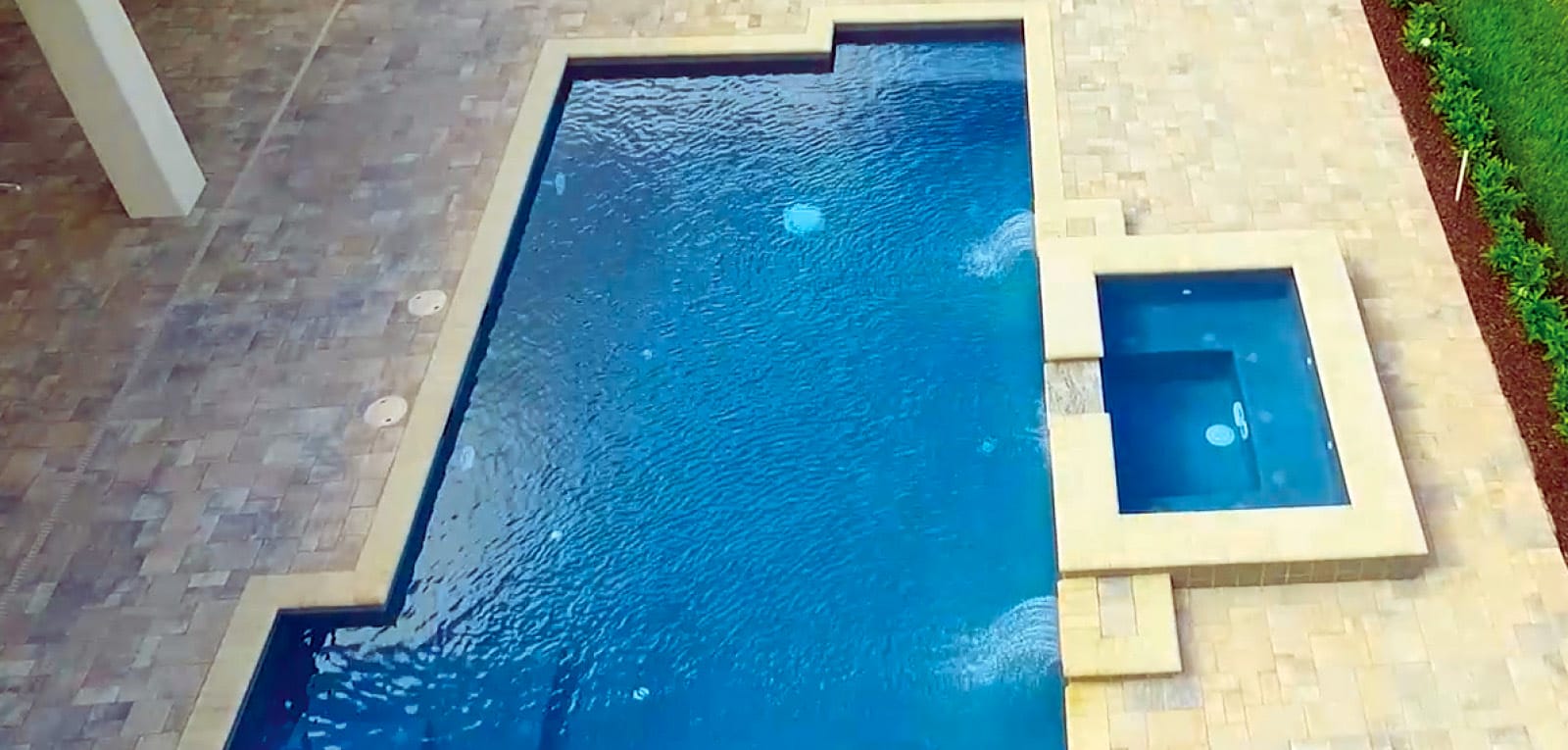 Gunite pool in a custom-altered rectangle-shaped with a rectangle spa.