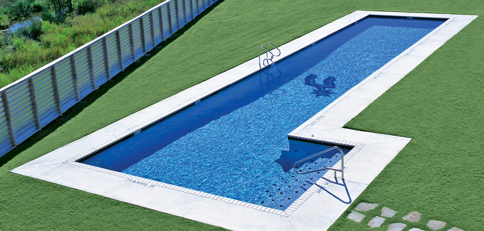 L-shaped gunite pool with in-floor mosaic of a boot spur.