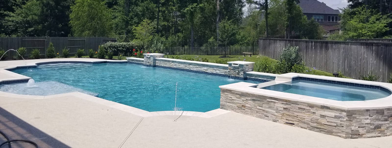 Roman swimming pool with spa built by Blue Haven Pools Houston.