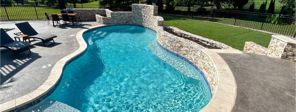 Curvy custom pool with sparkling blue water in Louisville. 