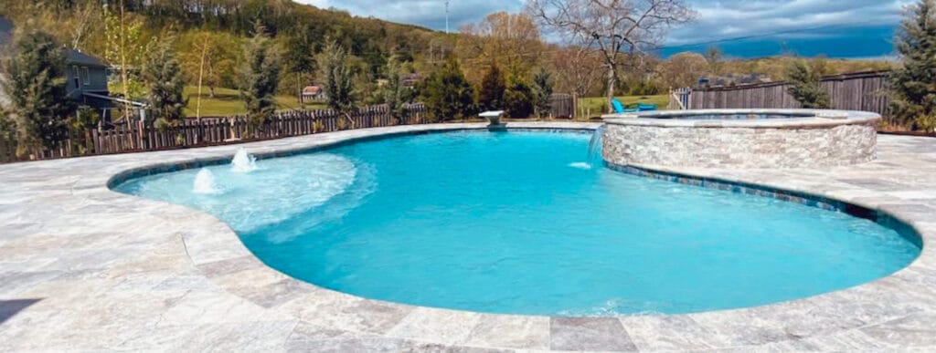 Freeform gunite pool with bubbler fountains and spa in Nashville.