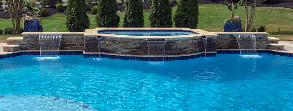 Roman-shaped custom spa and water features on inground pool in Franklin.