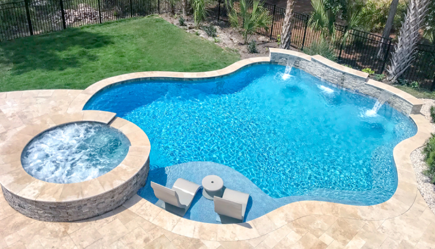 Curvy swimming pool with round spa and sun ledge.