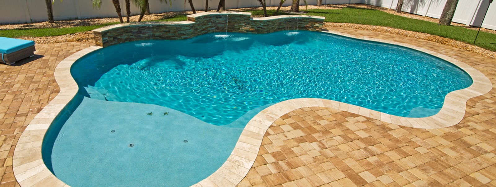Free-form custom pool with paver decking in Jacksonville.