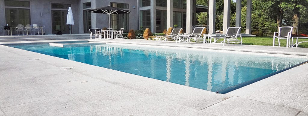 Inground rectangle-shape pool with interior spa in Fairfield backyard.