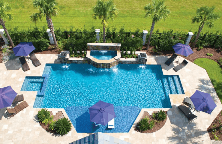 geometric inground pool with large tanning ledge, interior spa, and a large cascade waterfall fountain