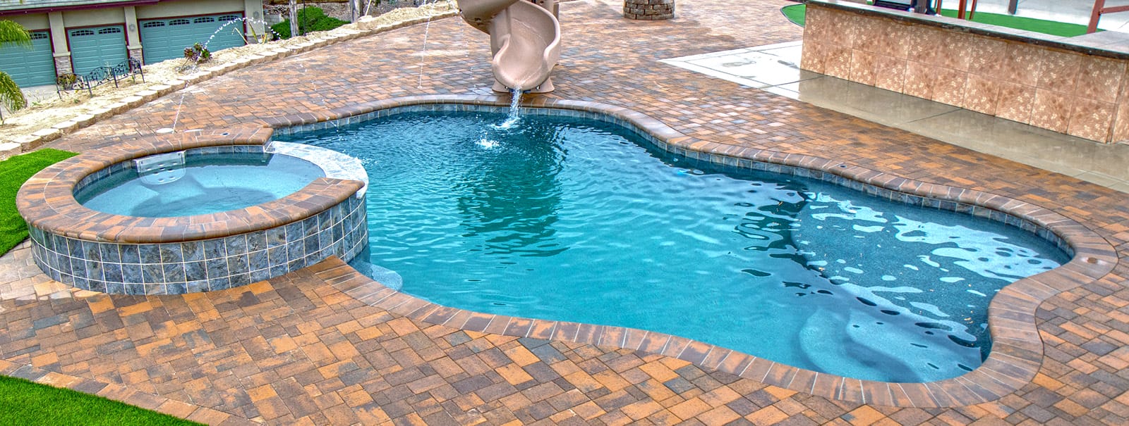Curvy San Diego  pool with paverstone decking.