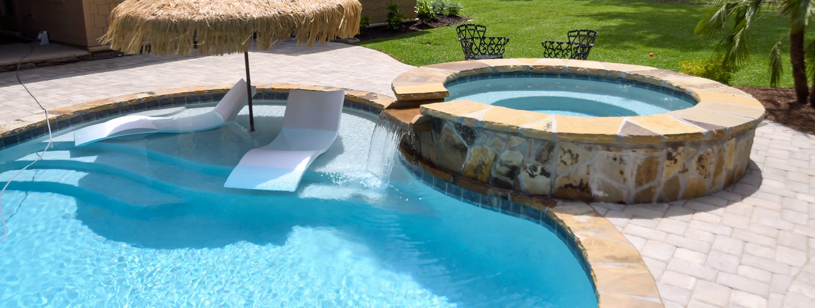 Gunite pool-spa with tanning ledge.
