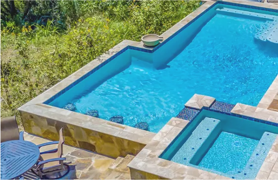 Modified rectangular swimming pool with in-pool barstools.