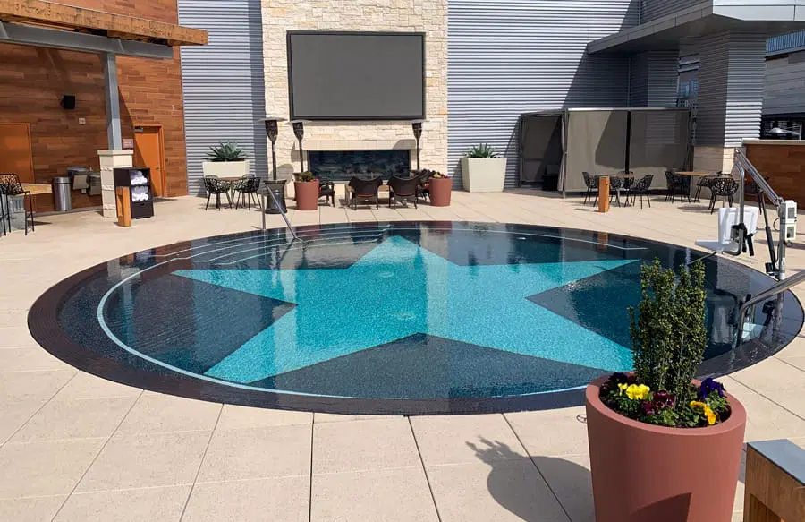 Round swimming pool with Texas star mosaic in bottom.