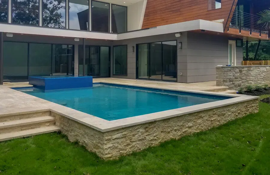 Rectangle inground pool with blue-tiled spa in Fayetteville.