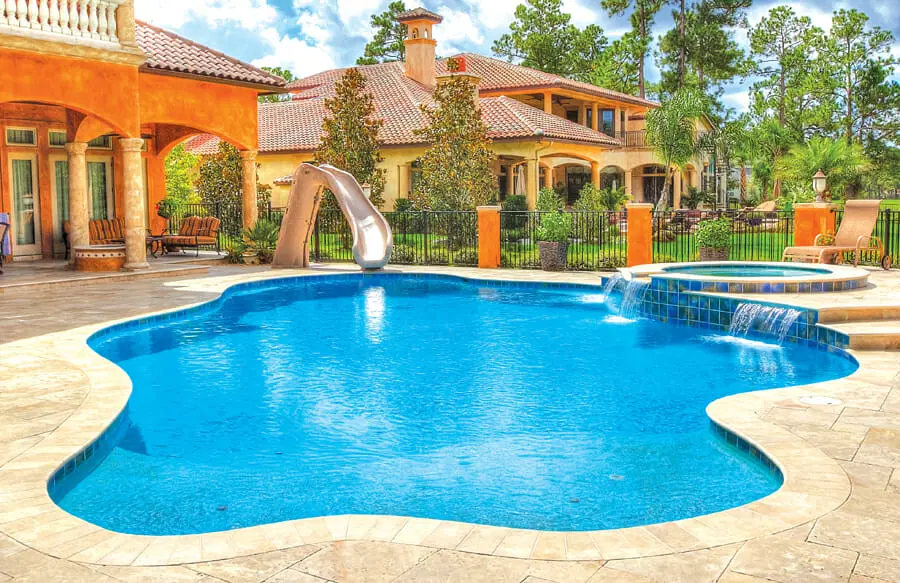 Large gunite pool with water slide in Lumberton home.