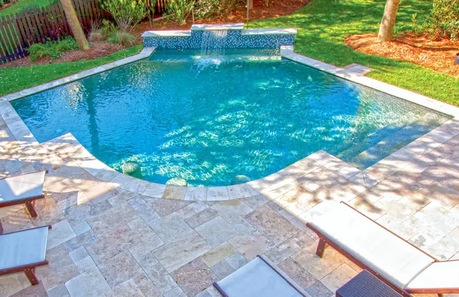 Modified square-shape swimming pool with cascade water feature.