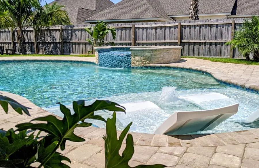 Deland swimming pool with spa and tanning ledge.