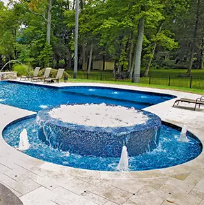 Custom pool with rimflow spa and fountains.