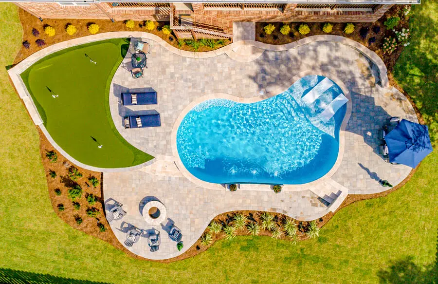 Backyard in Mobile with pool, fire pit, and putting green.