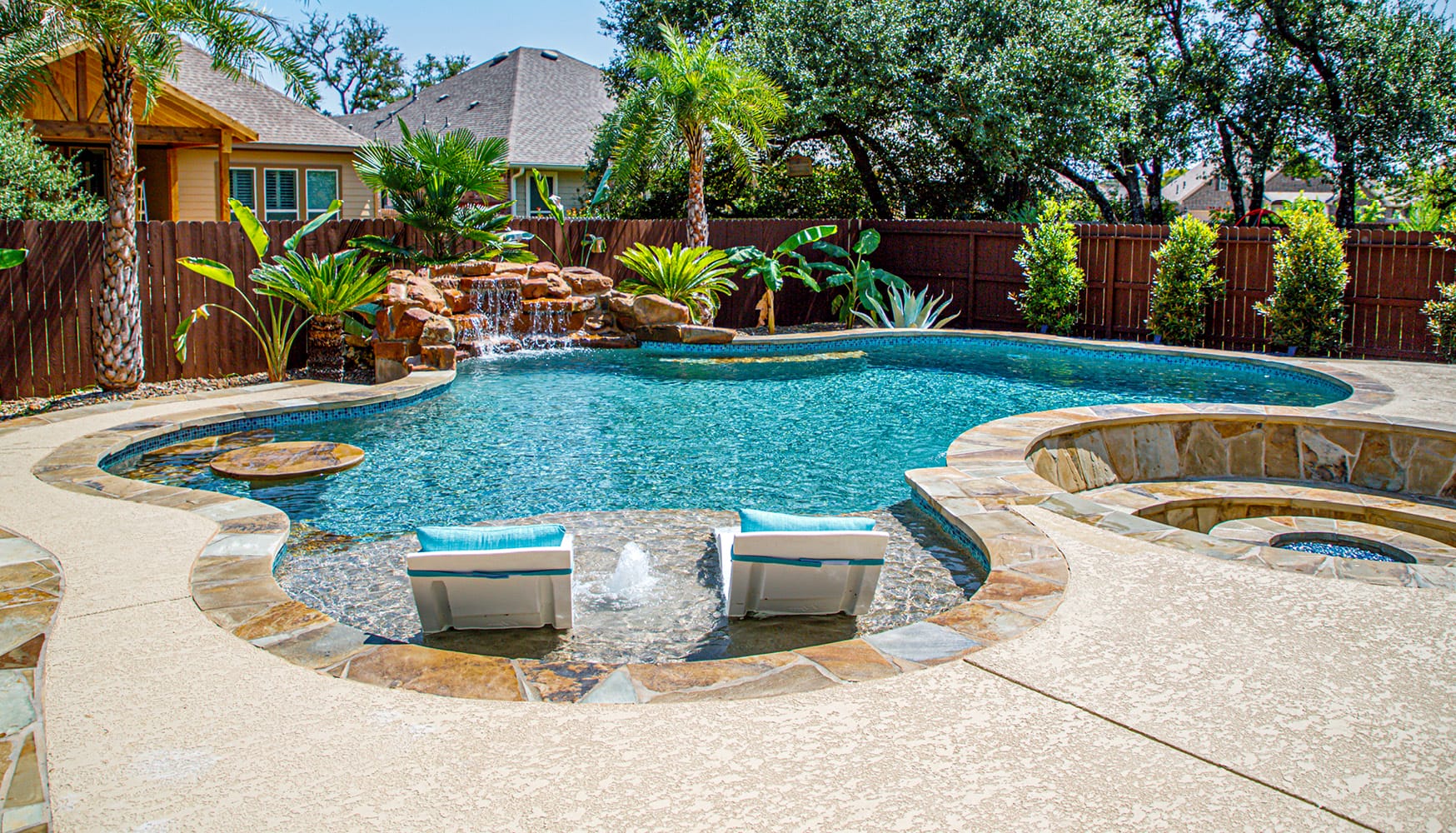 Lagoon-style gunite pool with a swim-up table and integrated fire pit.