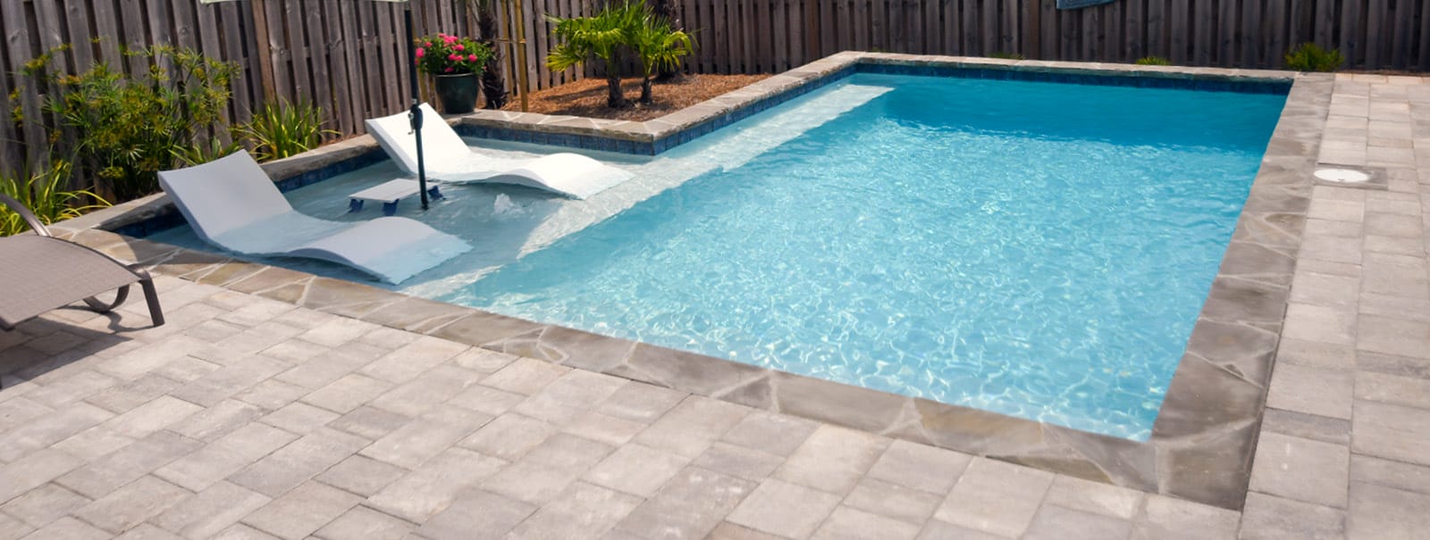 Tanning ledge on rectangular inground pool.