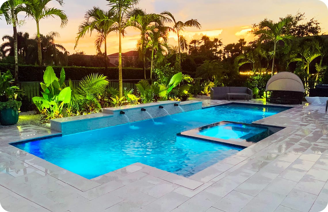 Modern custom pool-spa in Naples at sunset.