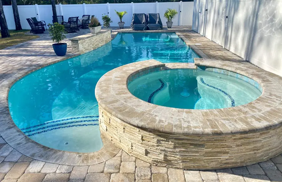 Stone-faced custom spa on inground pool in Bradenton.