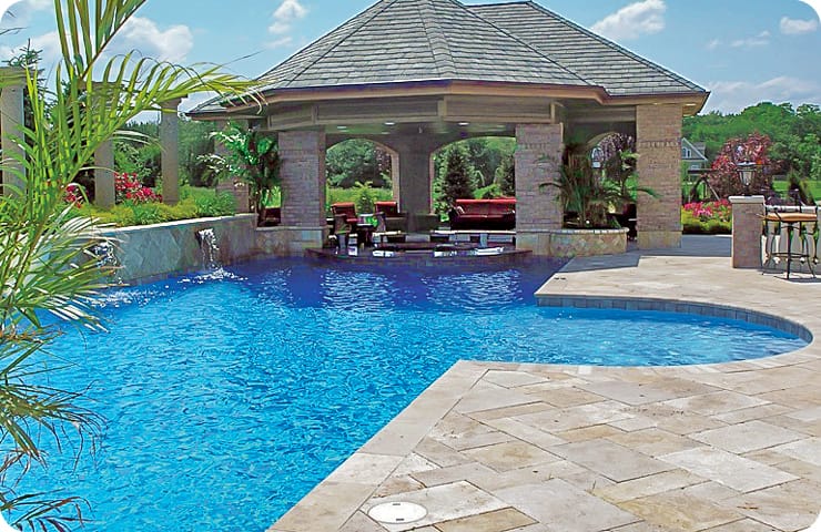 Swimming pool with large pavillion-covered swim-up bar and outdoor kitchen.