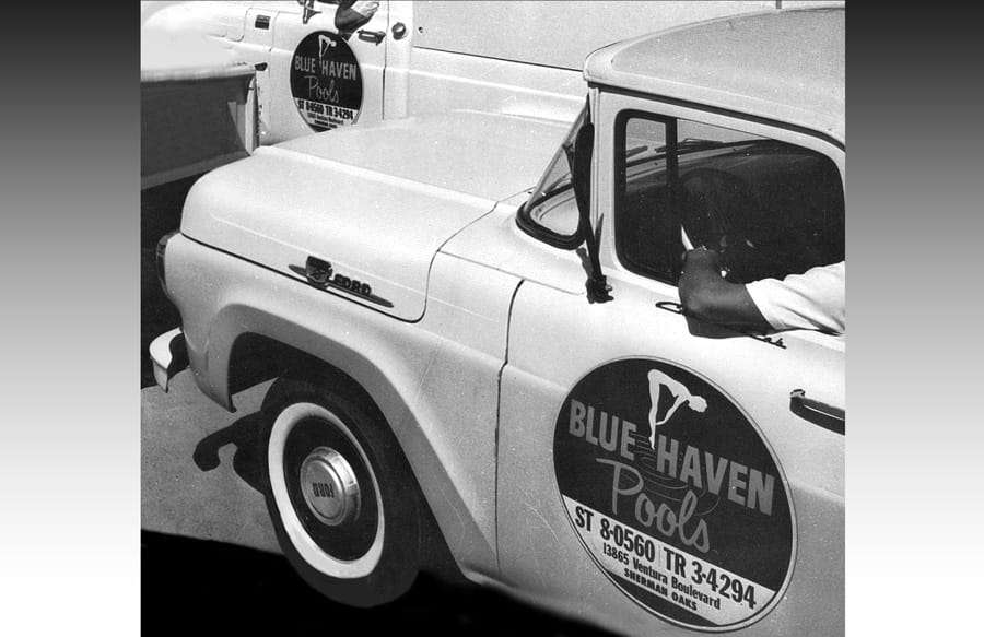 Black and white photo of mid-Century pick-up truck with Blue Haven logo on door.
