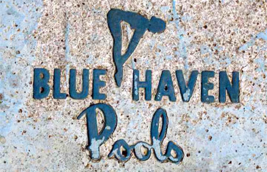 Retro Blue Haven Pools Logo plaque embedded into concrete pool step.