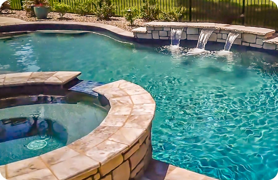 Gunite pool and spa with trio cascade water features.