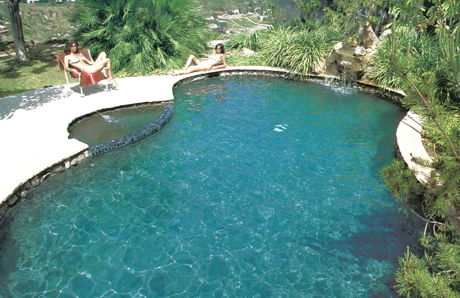 Late 1970s lagoon-style swimming pool with rock waterfall.