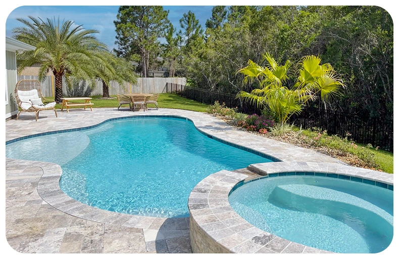 Curvy swimming pool with a round hydrotherapy spa in a backyard.