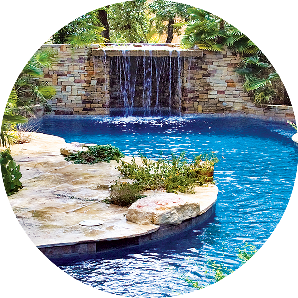 Stack-stone grotto waterfall on organic-style custom pool.