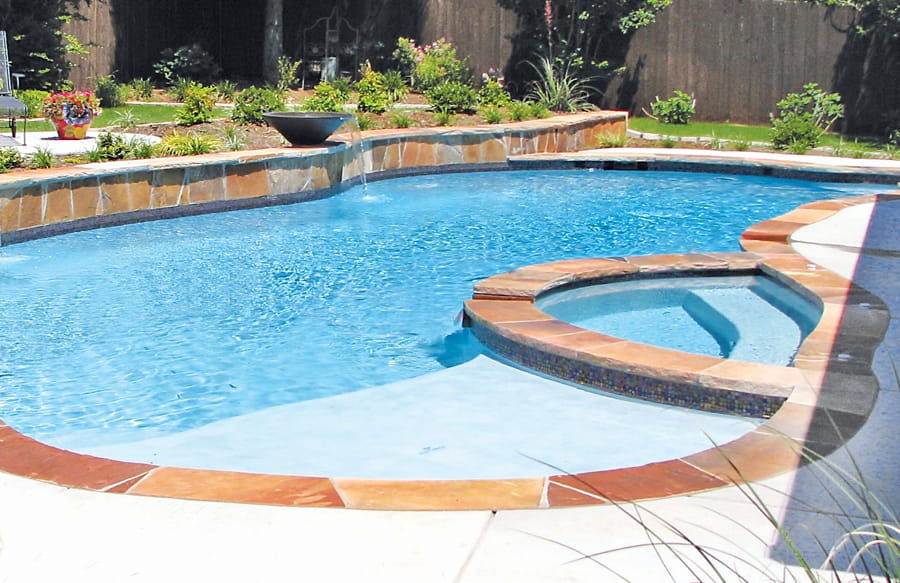Pool with interior spa trimmed in flagstone coping.