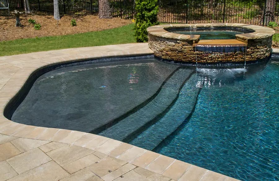 Entry steps to swimming pool with the oversized first step.