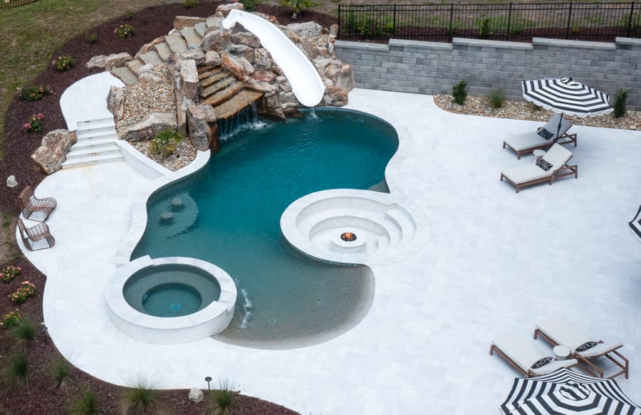 Lagoon-style pool in Raleigh with rock waterfall and conversation pit.